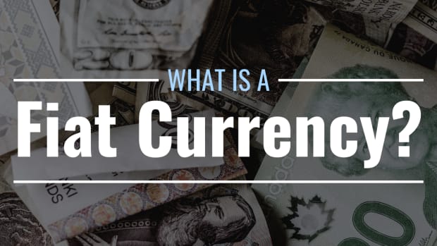 Darkened photo of a pile of paper money from various countries with text overlay that reads "What Is a Fiat Currency?"
